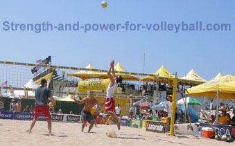 AVP beach volleyball spiking at the net