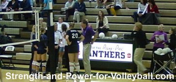 Volleyball officials communicating with teammates and scorekeeper